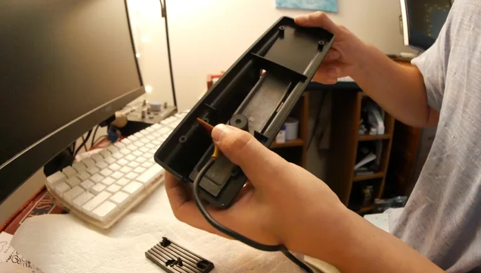 Identify the mechanism: Locate the small button that activates the sustain function and the contact pad it pushes against.