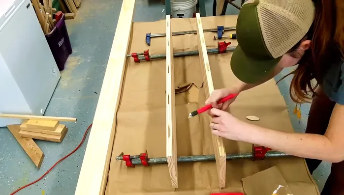 Create half-laps on the legs to receive the cross braces. This involves precisely measuring and cutting half-inch recesses.