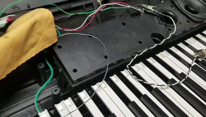 Mount the new jack to the chassis using hex nuts and washers, ensuring a secure fit.