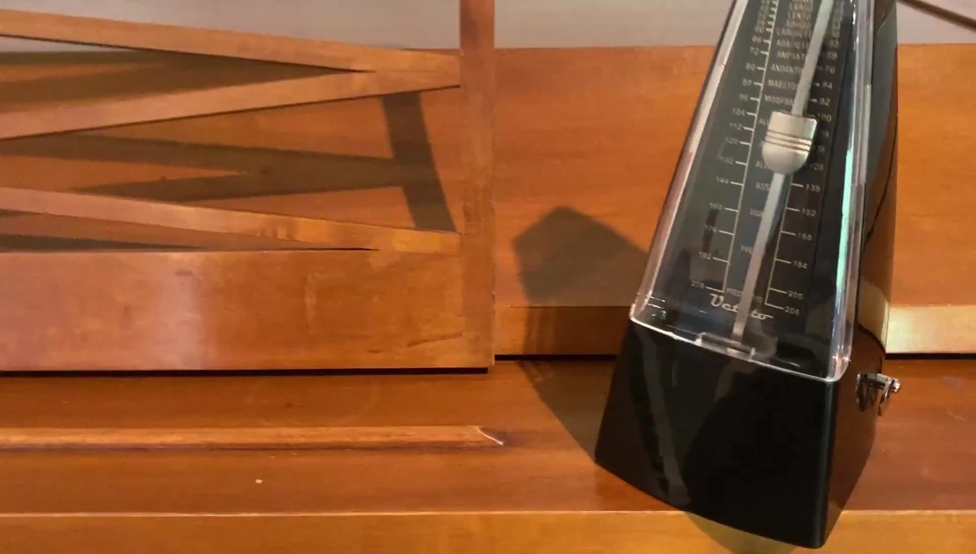 The side of the metronome showing the winding mechanism.