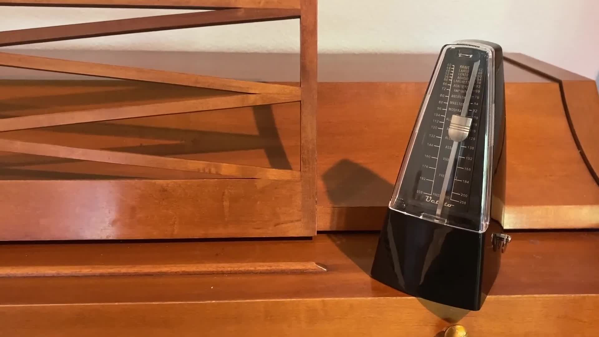 Close-up of the black Ueteto mechanical metronome in its case.