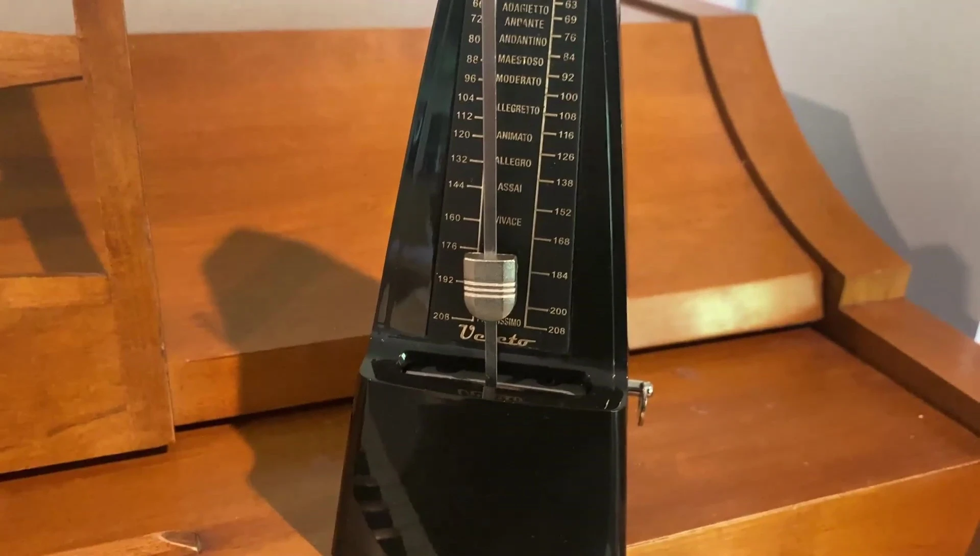 Hand winding up the metronome.