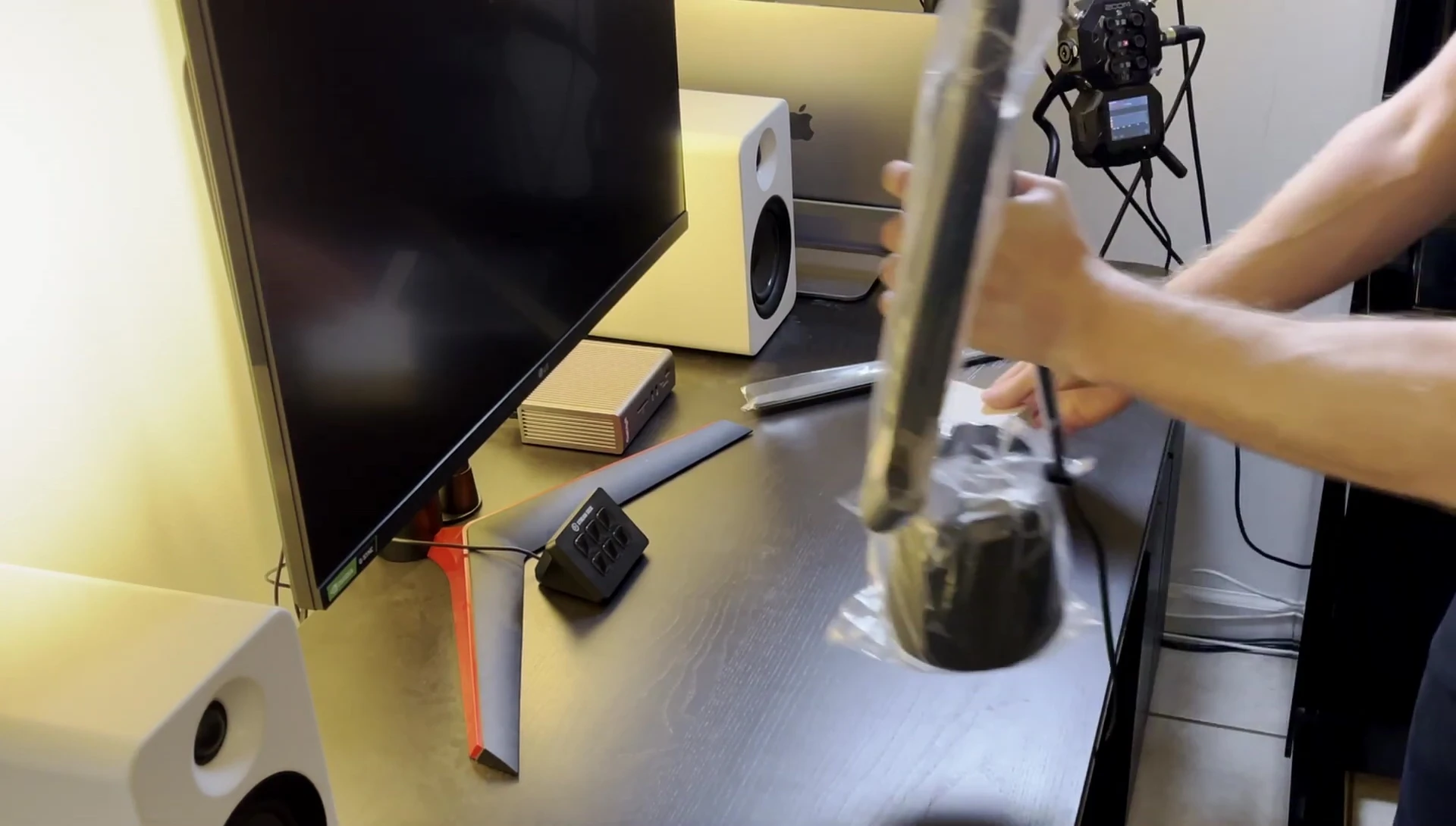 The BenQ Piano Light being carefully removed from its packaging.