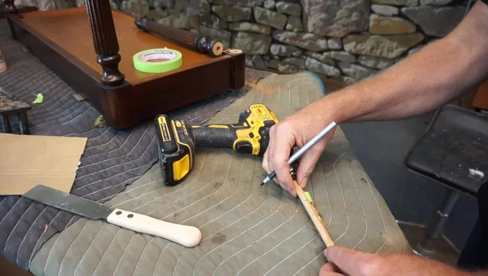 Apply wood glue to the 3/8 inch holes on both the leg and the bench base. Insert the notched dowel, ensuring a firm fit.