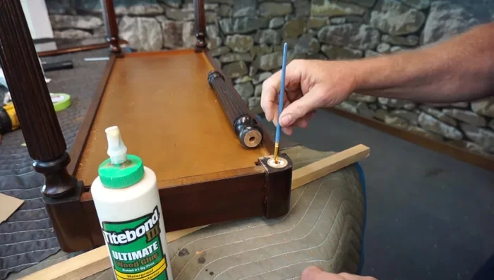 Apply wood glue to the 3/8 inch holes on both the leg and the bench base. Insert the notched dowel, ensuring a firm fit.