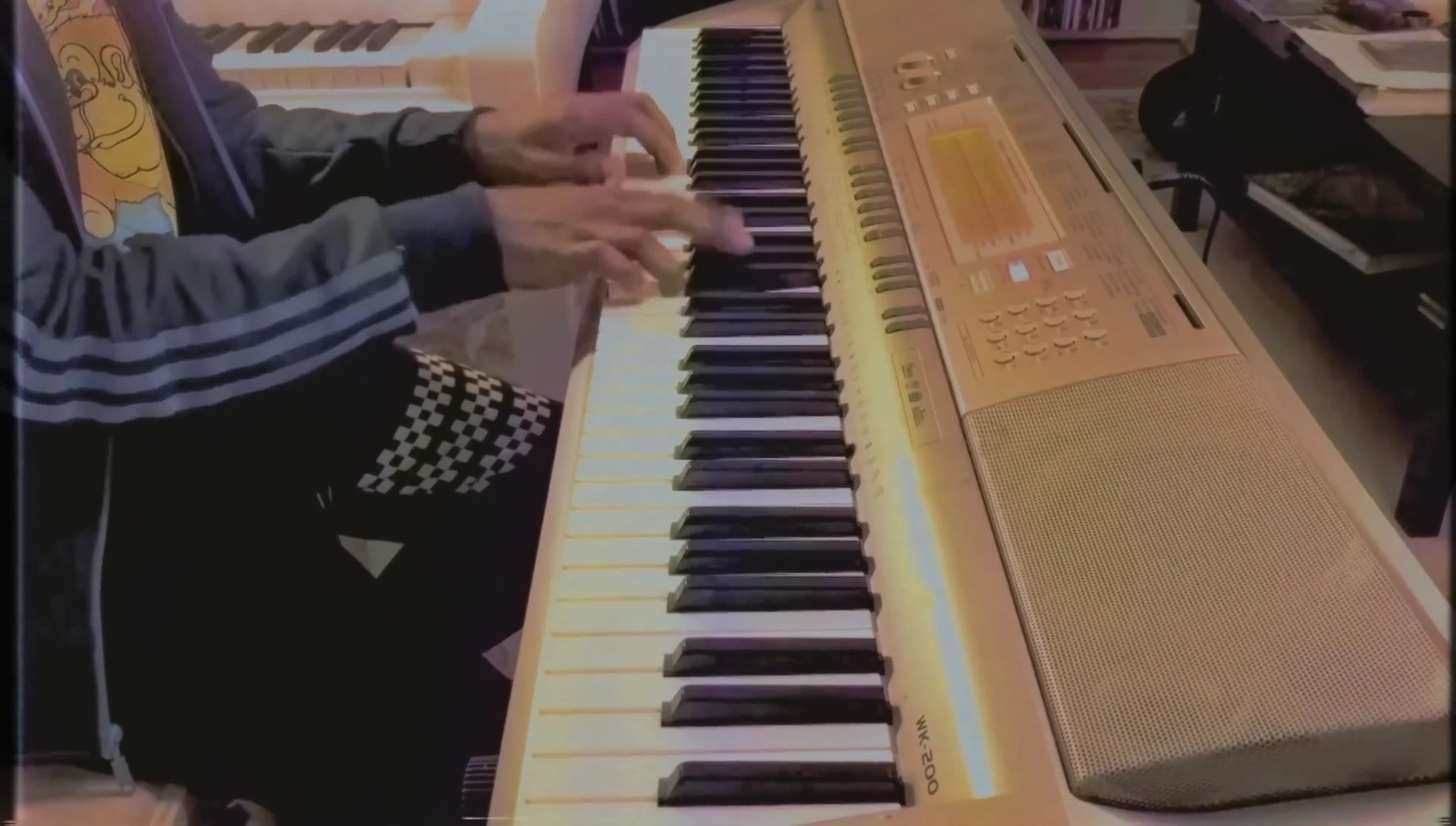 A shot showcasing the pianist playing a more lively and upbeat passage.
