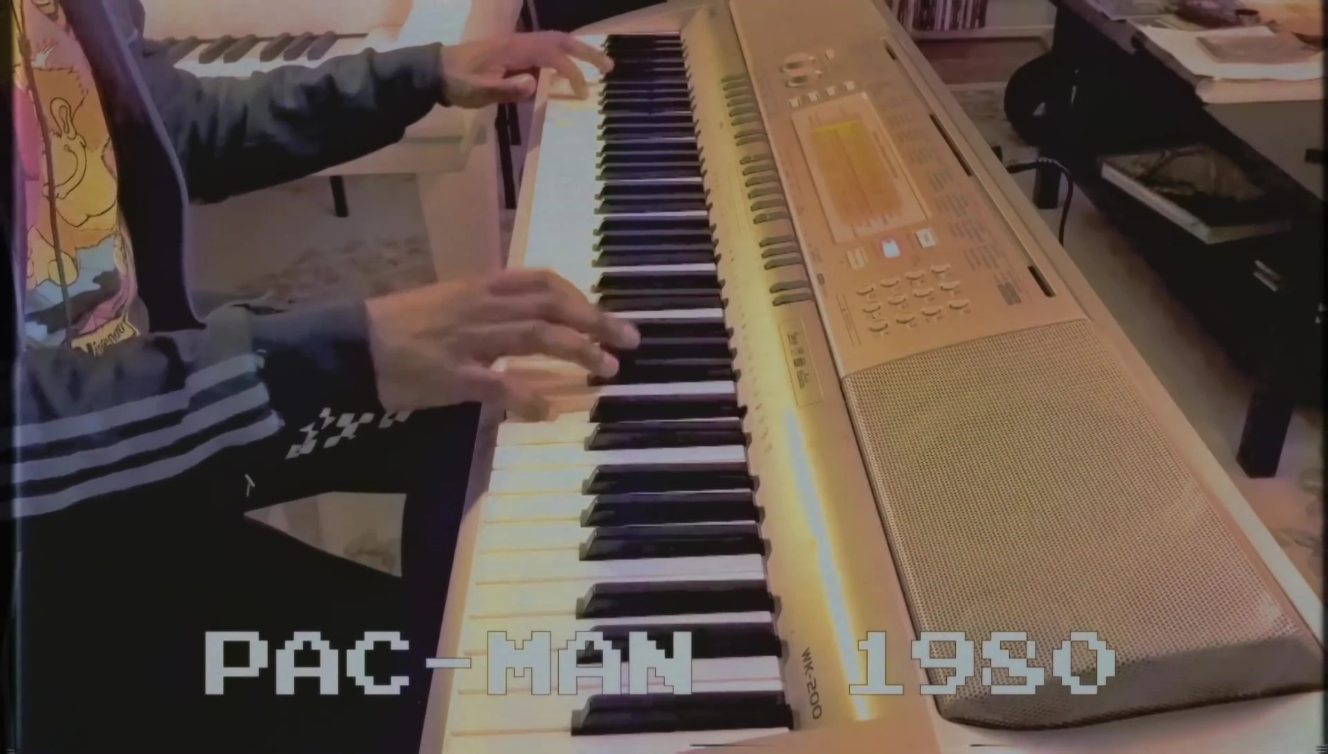 A wider shot, showing the pianist performing a more expressive passage.