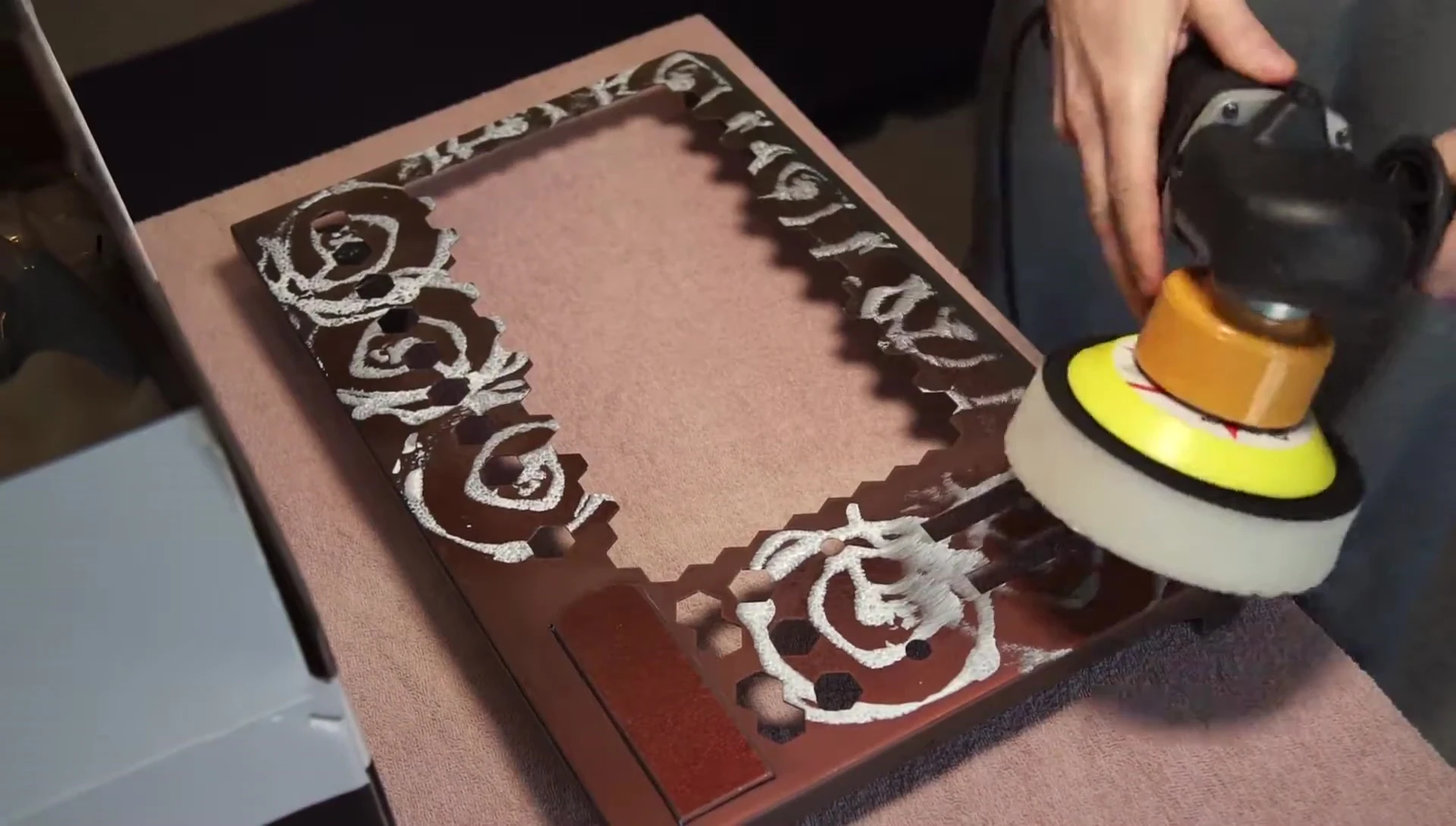 Using a polishing machine to achieve a glossy finish.