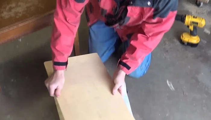 Cut a piece of vinyl large enough to wrap around the wood and foam.