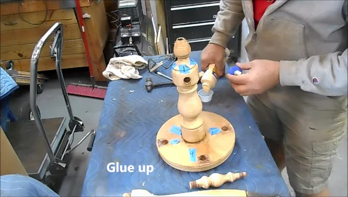 Glue and clamp: Apply wood glue to the joints and clamp the stool securely. Use a combination of band clamps and spring clamps to ensure even pressure and prevent clamping slippage on angled surfaces. Add weights on top of the seat to ensure a tight fit between the seat and legs.