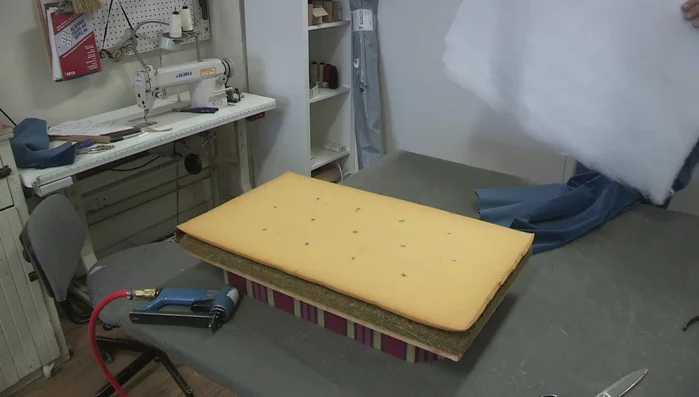 Secure the Dacron. Staple the Dacron to the sides of the wooden frame, avoiding the bottom edge to minimize bulk.