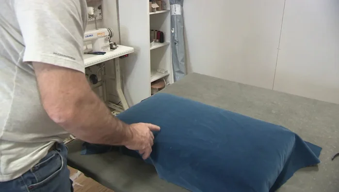 Prepare the fabric. Address any wrinkles or roll marks using a fabric spray like 'Spring Mist'.