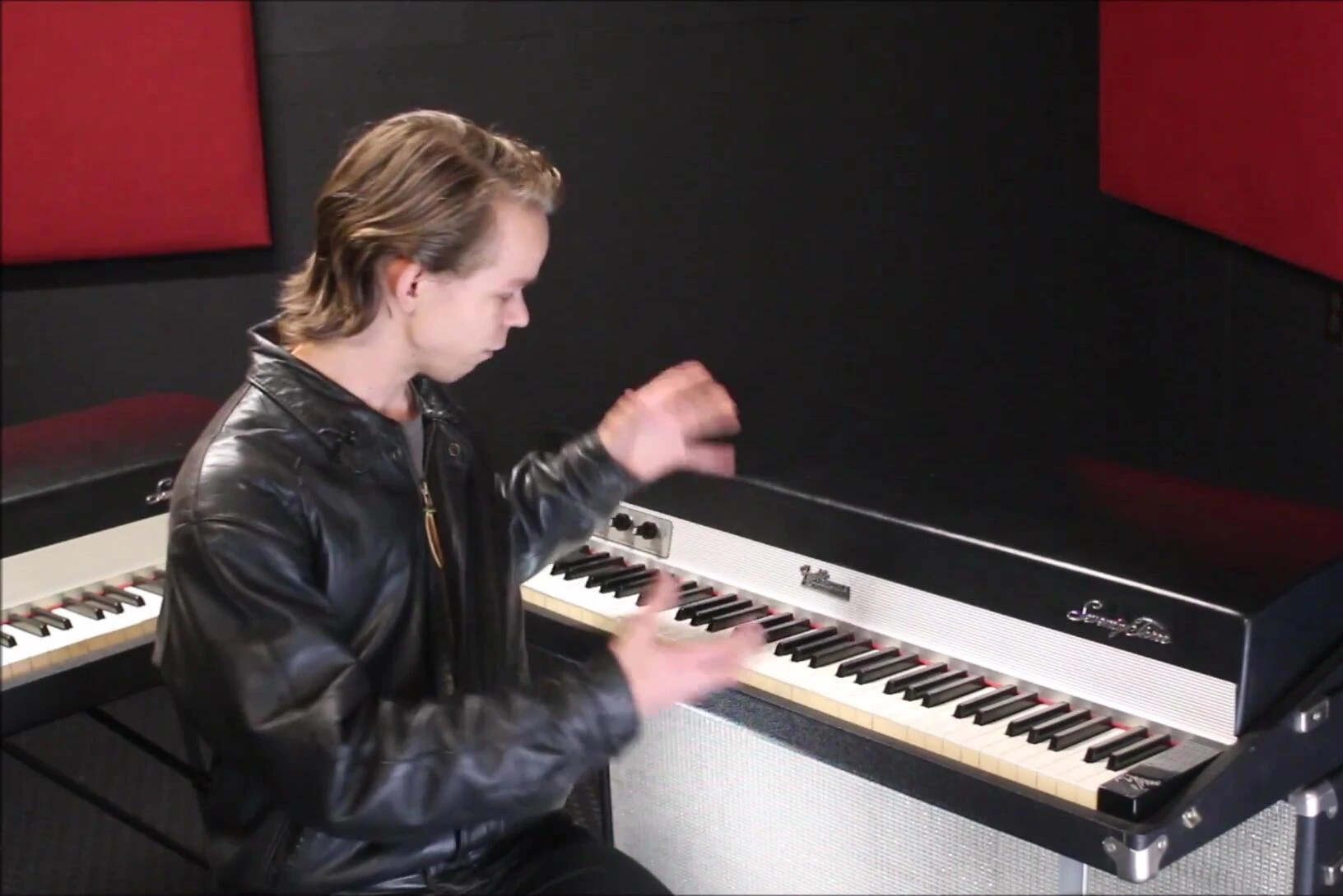 The speaker playing the Fender Rhodes, focusing on the unique sound of the instrument.