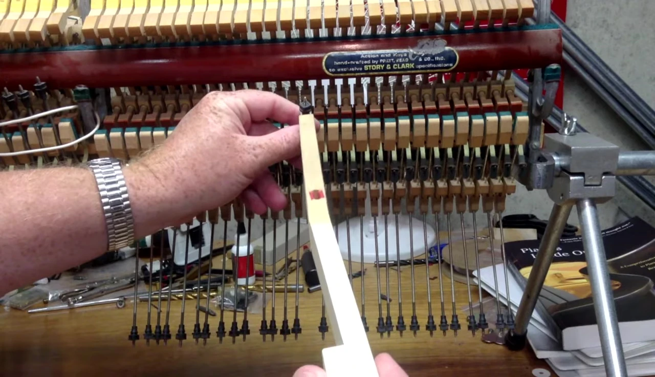 A piano key showcasing the attachment point for the lifter wire.