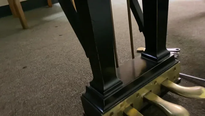 Remove the plate screws at the front of the piano, keeping them in order.