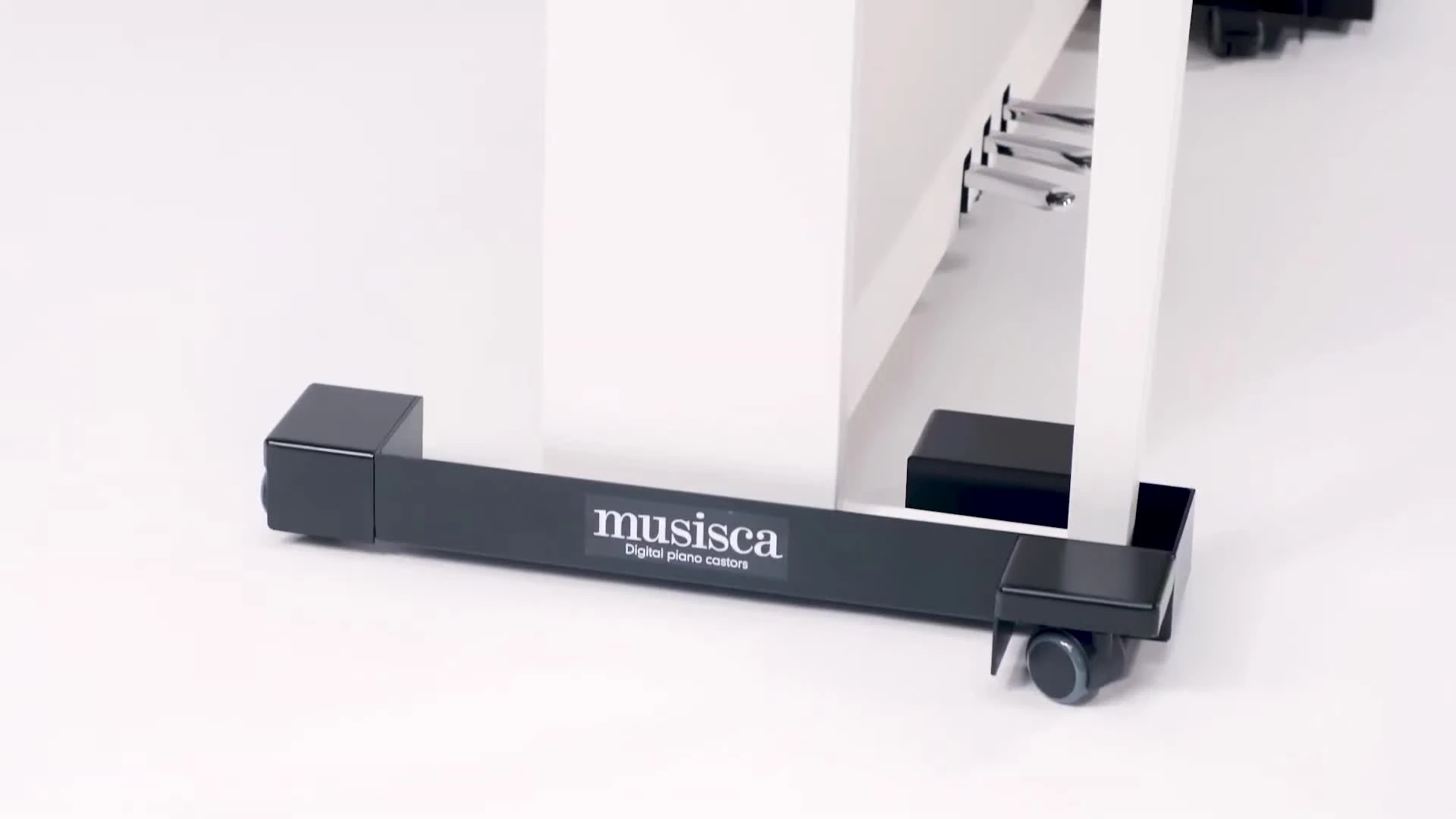 Close-up of the castor glide being slid under a piano leg