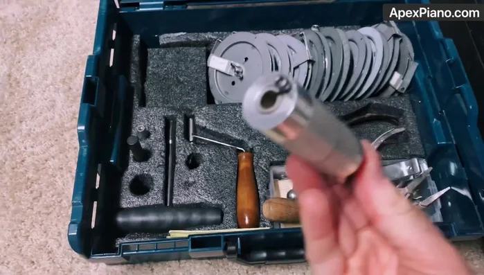 Using the string hook and coil maker, create and install new coils onto the tuning pins.