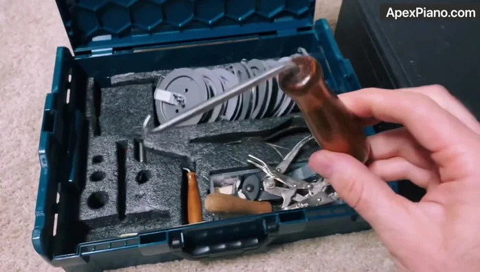 Using the string hook and coil maker, create and install new coils onto the tuning pins.