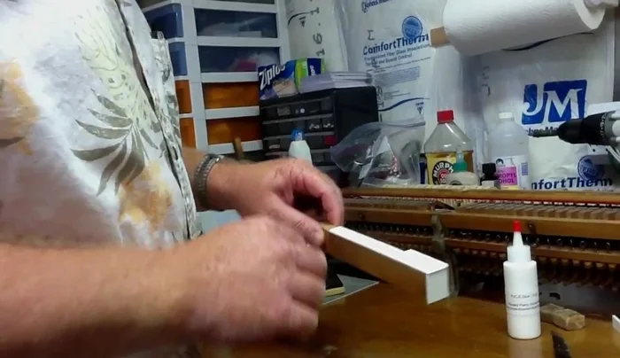 File the excess key top material until flush with the wood, being careful not to scratch the key top.