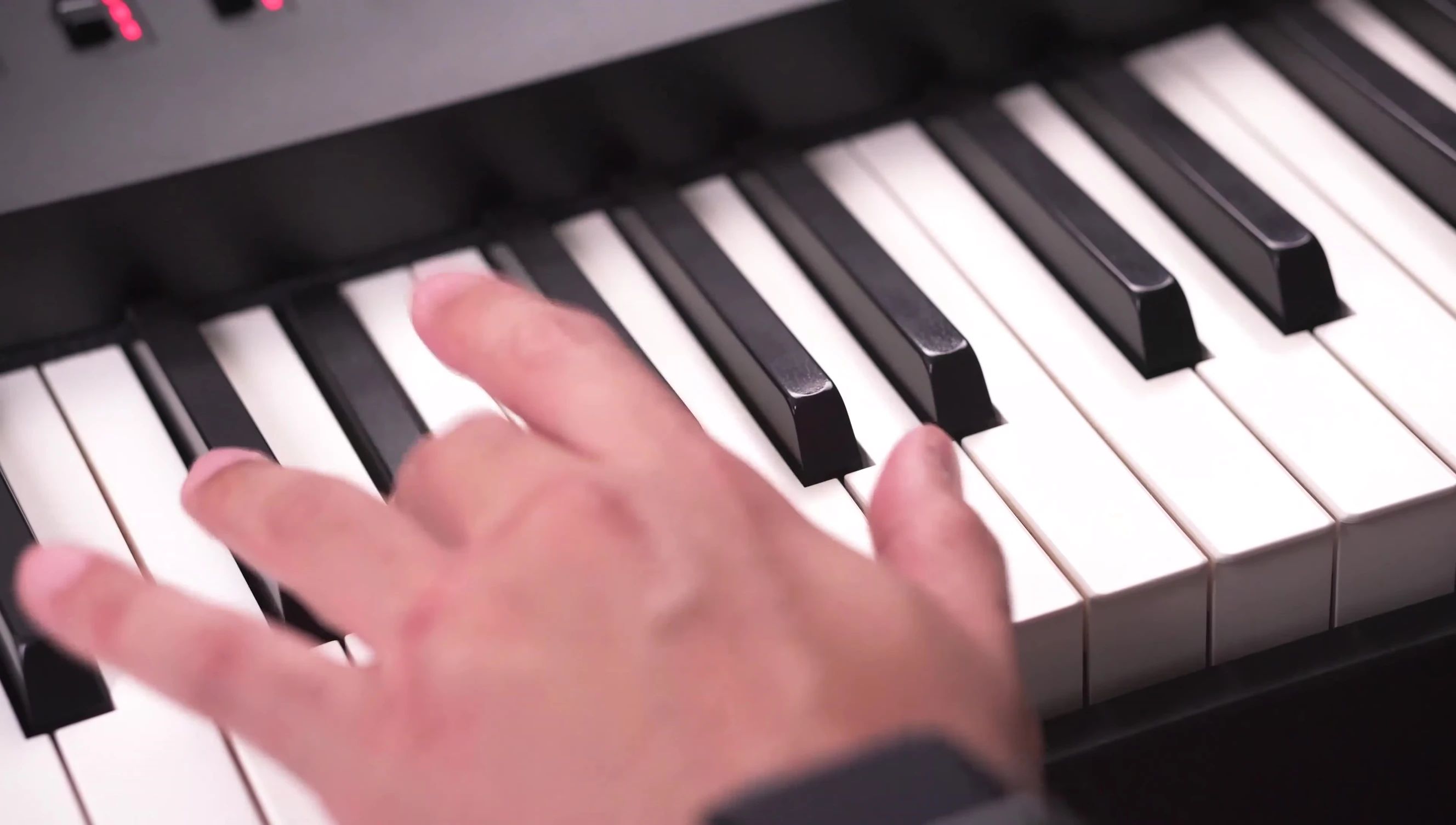 The performer actively playing the keyboard, showcasing responsiveness