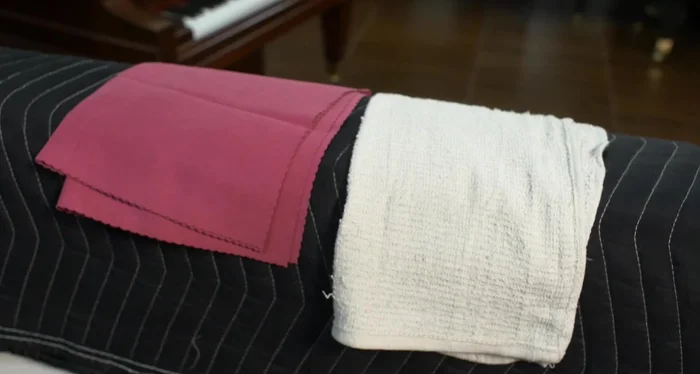 Rub in the direction of the wood grain.