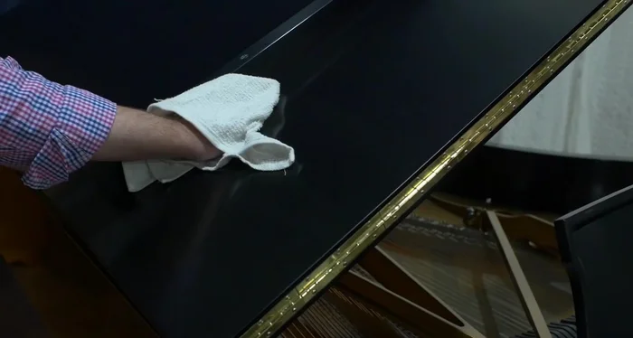 Rub in the direction of the wood grain.