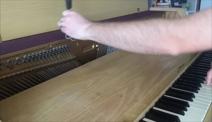 Identify the strings corresponding to middle C using the hammer's strike point and mute the unwanted strings using wedge mutes.