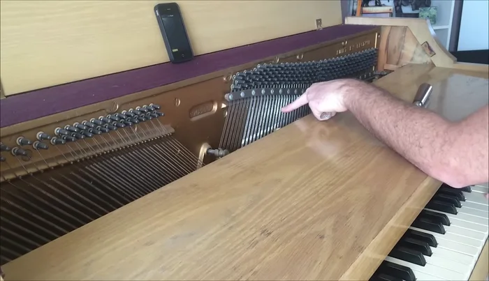 Identify the strings corresponding to middle C using the hammer's strike point and mute the unwanted strings using wedge mutes.