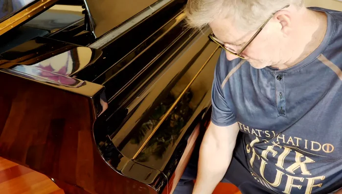 Carefully remove the keyboard cover, ensuring not to scratch the piano.