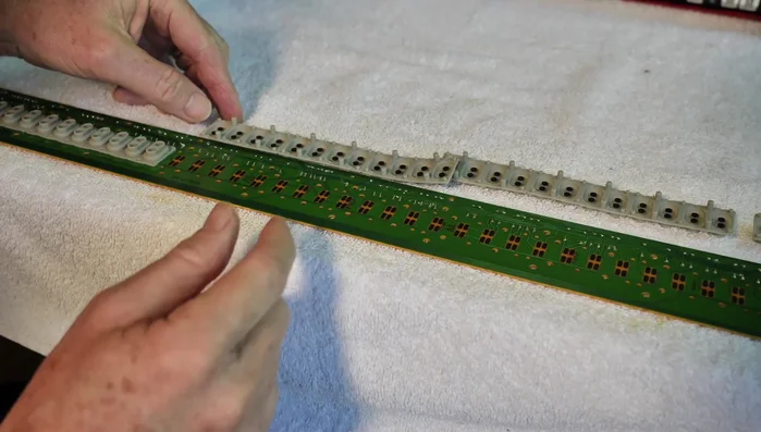 Reassemble the keyboard and piano, paying careful attention to the alignment of components and securing screws properly. Ensure all ribbon cables are correctly reconnected.