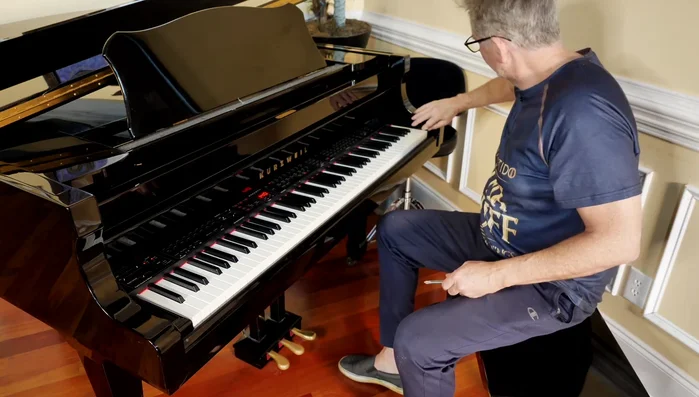 Carefully remove the keyboard cover, ensuring not to scratch the piano.